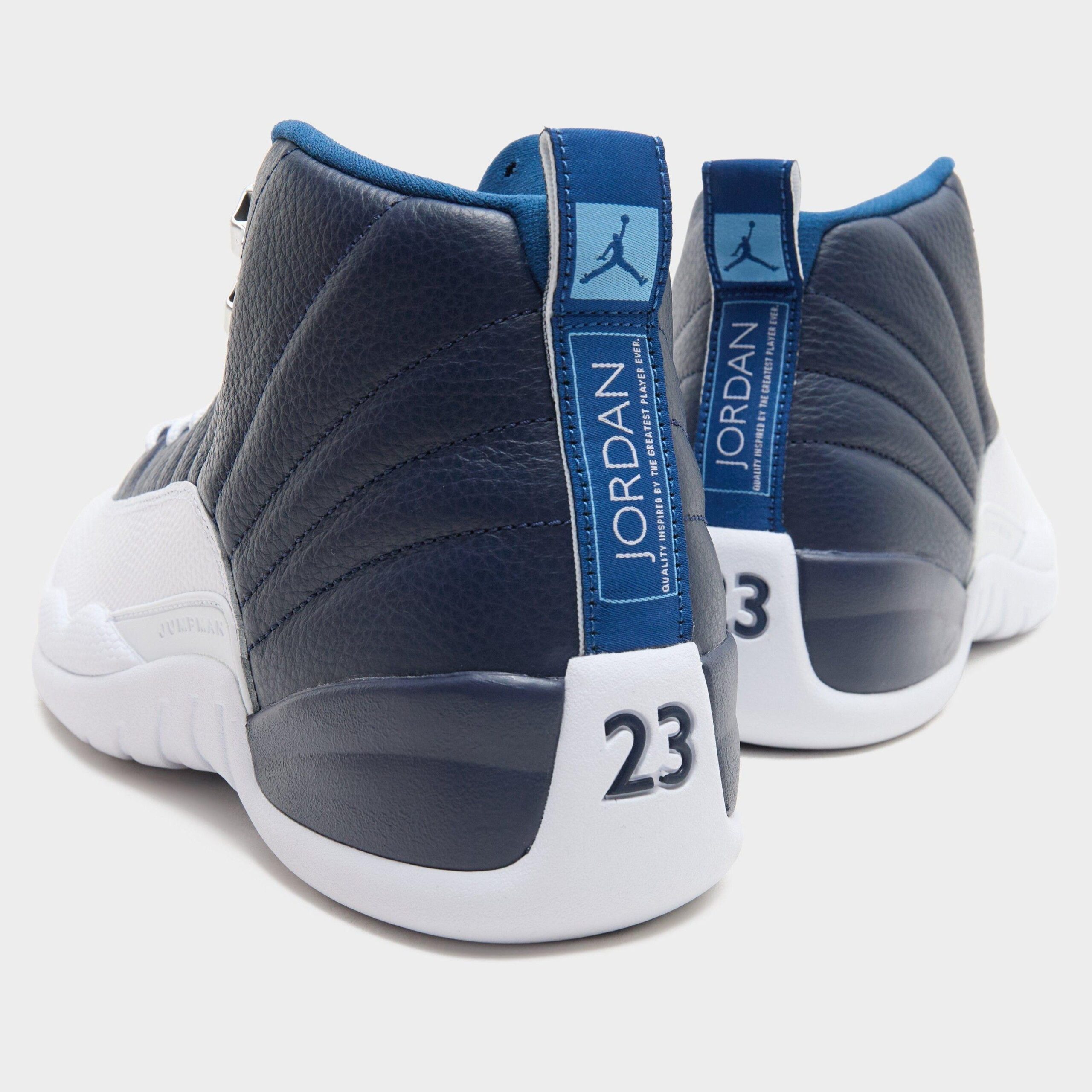 Heel view of a pair, blue JORDAN heel tab, light blue Jumpman and white heel with 23, Obsidian