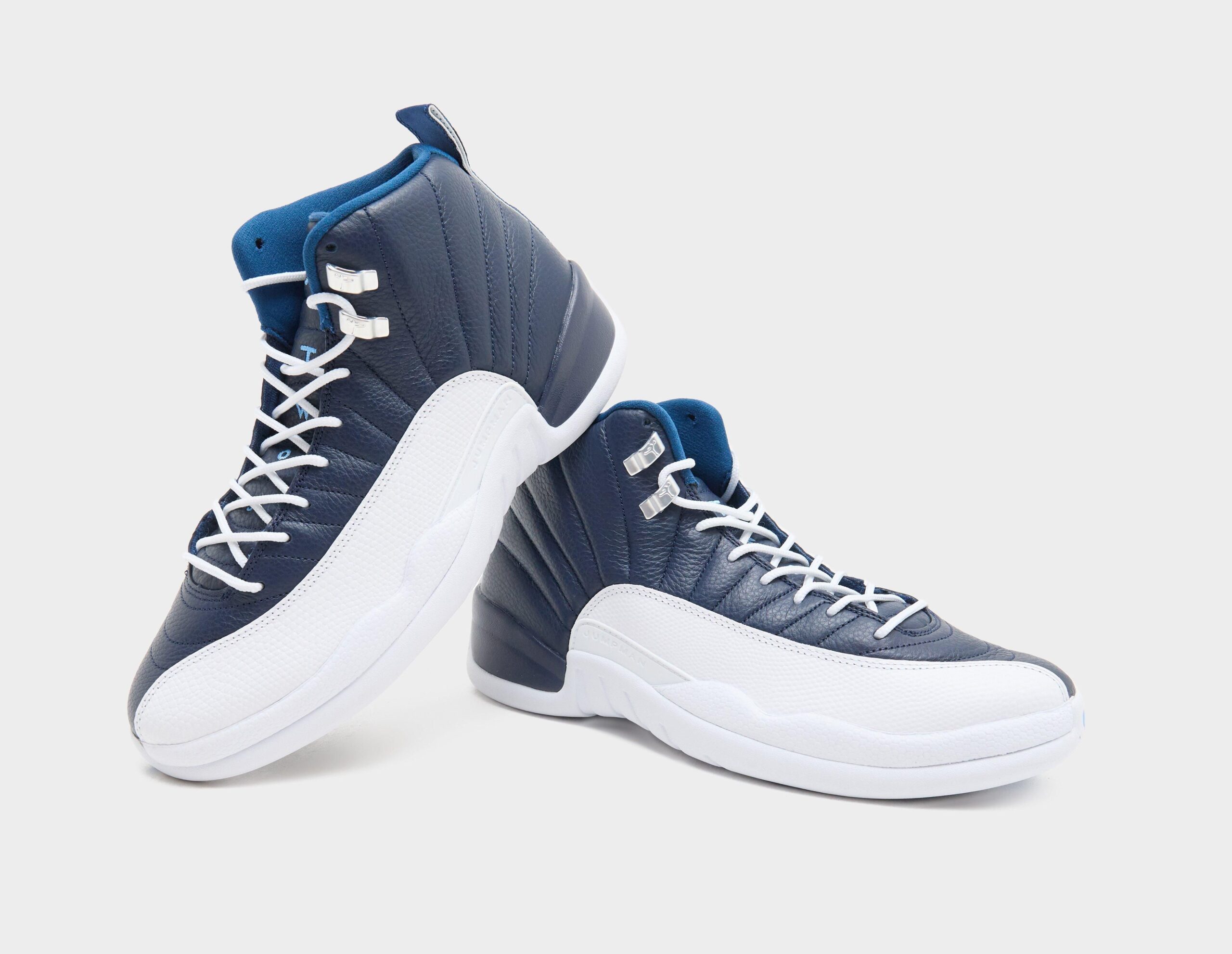 Pair angled together, navy quilted leather, white mudguards and laces, silver eyelets, Obsidian