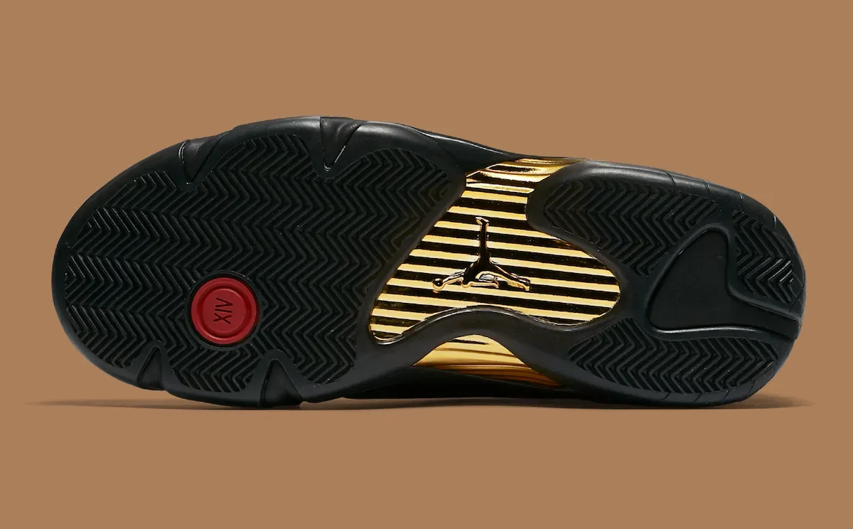 Outsole of black sneaker with herringbone tread, gold ribbed shank and red XIV badge, Defining Moments Pack