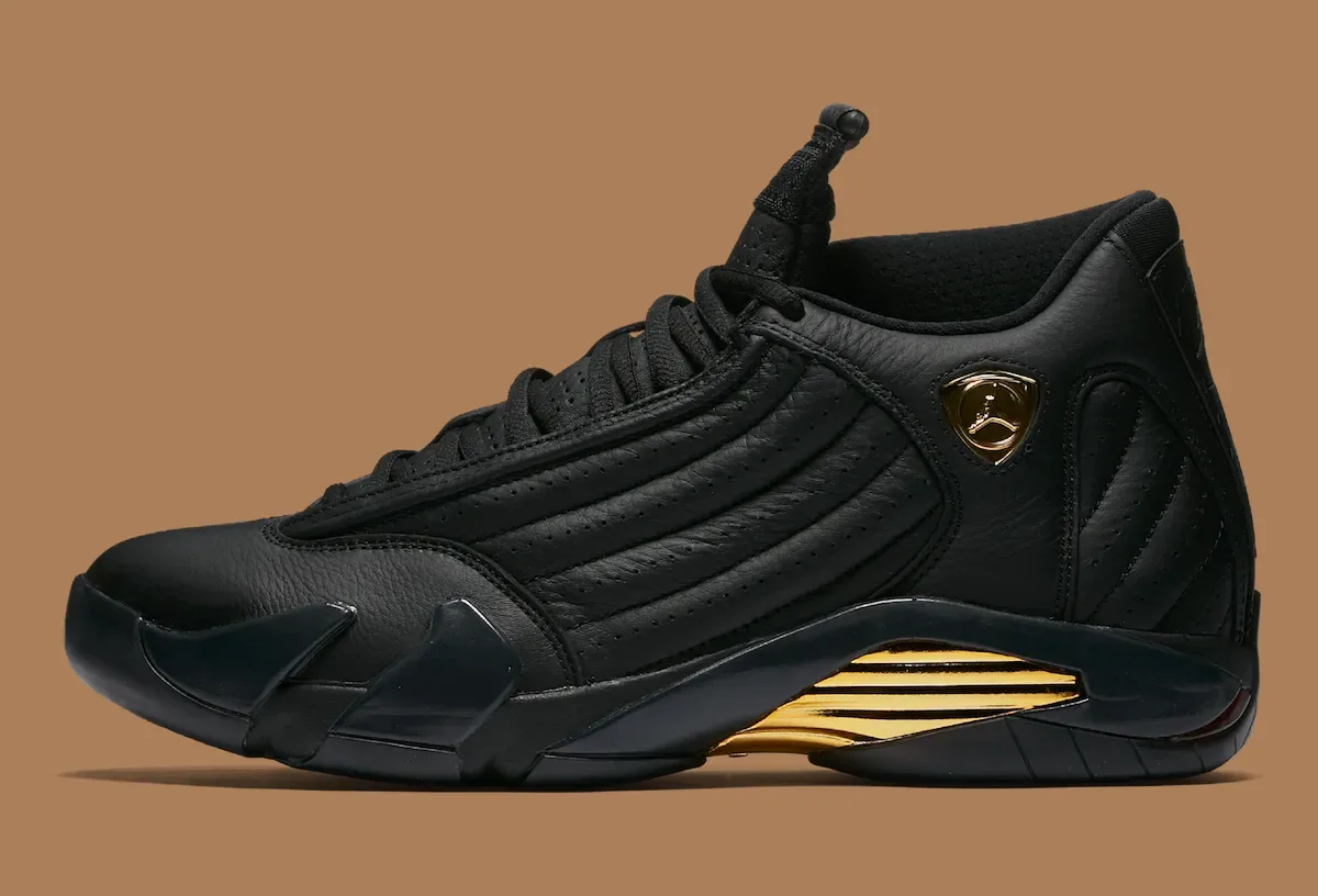 Lateral view of black quilted leather sneaker with gold shield badge and gold ribbed heel insert, Defining Moments Pack