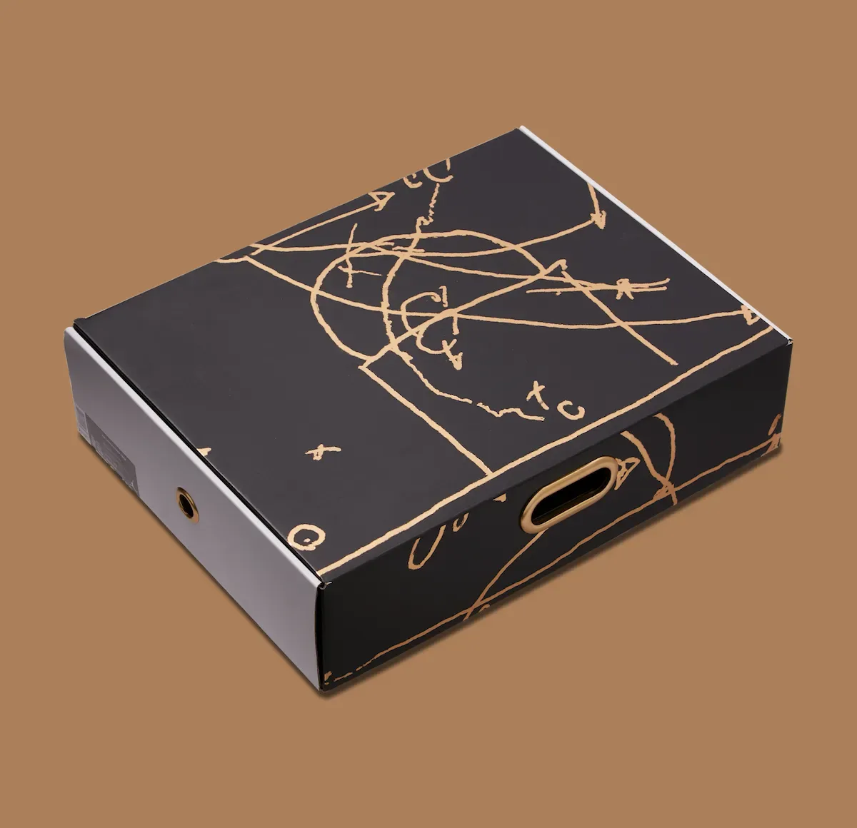 Packaging: black box with gold basketball play diagram drawings and gold oval handle on brown background, Defining Moments