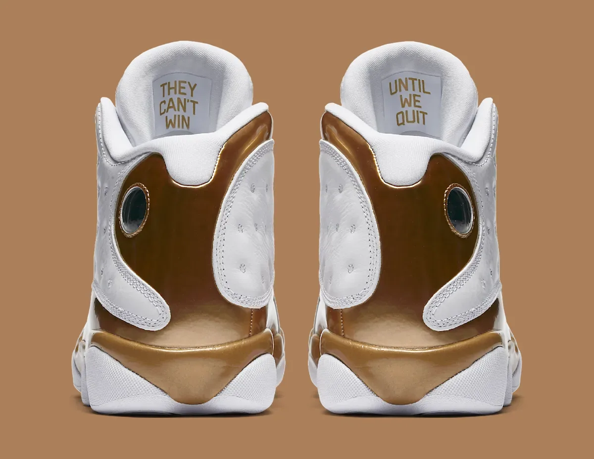 Heel view of two white sneakers with gold panels and insole text 'They can't win' and 'Until we quit', Defining Moments Pack