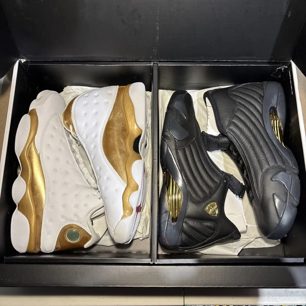 Top-down view of open black box with white-and-gold and black-and-gold pairs in tissue paper, Defining Moments Pack