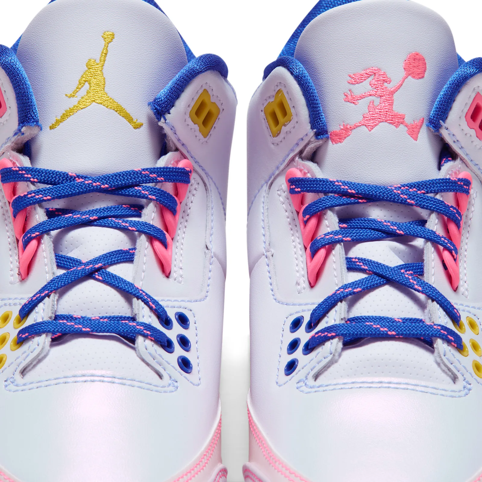 Detail of two tongues and lacing, yellow Jumpman and pink bunny embroidery, blue pink-flecked laces, yellow and blue