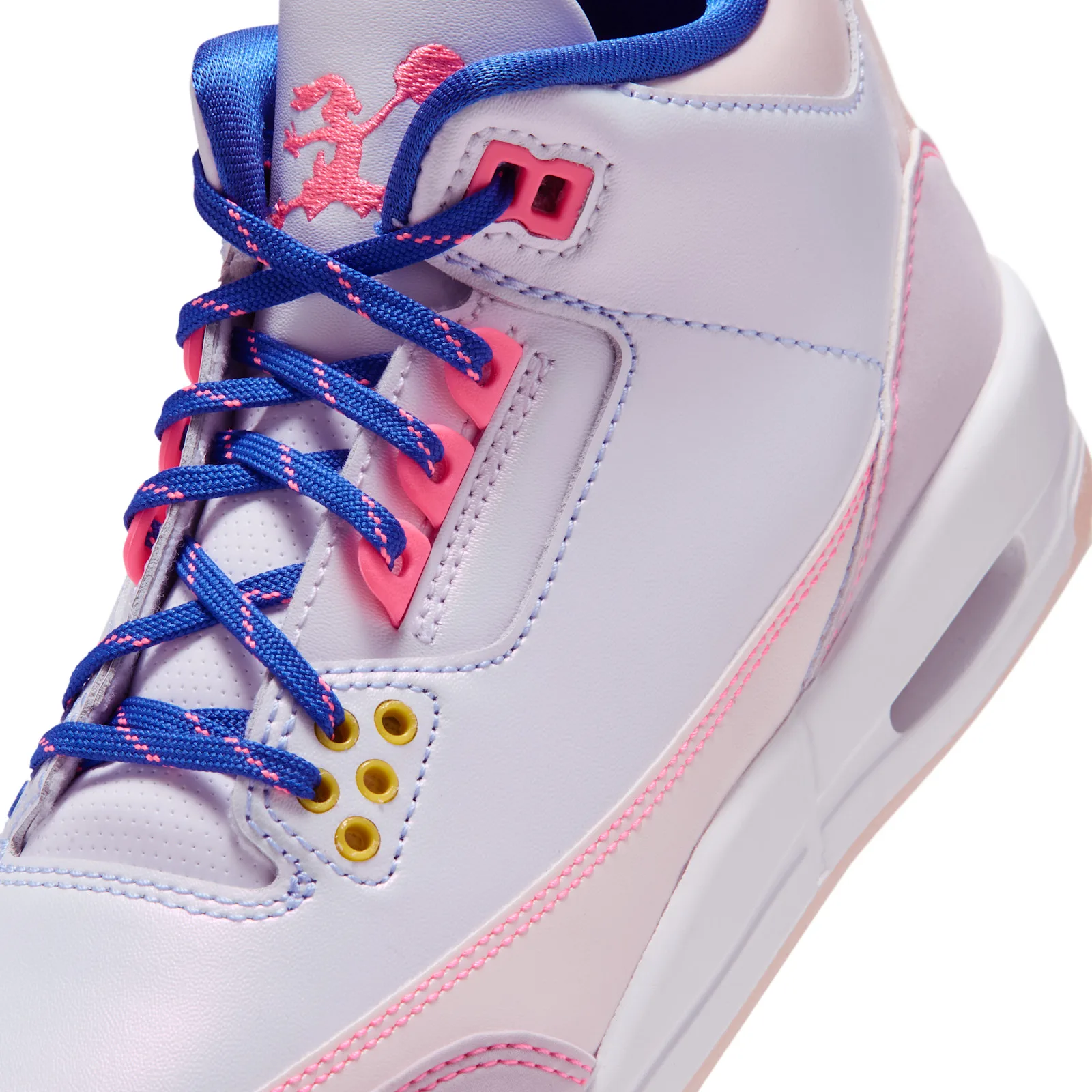 Detail of lacing and midfoot, blue laces with pink flecks, pink eyelet tabs, yellow eyelets and pink bunny logo, Lola Bunny