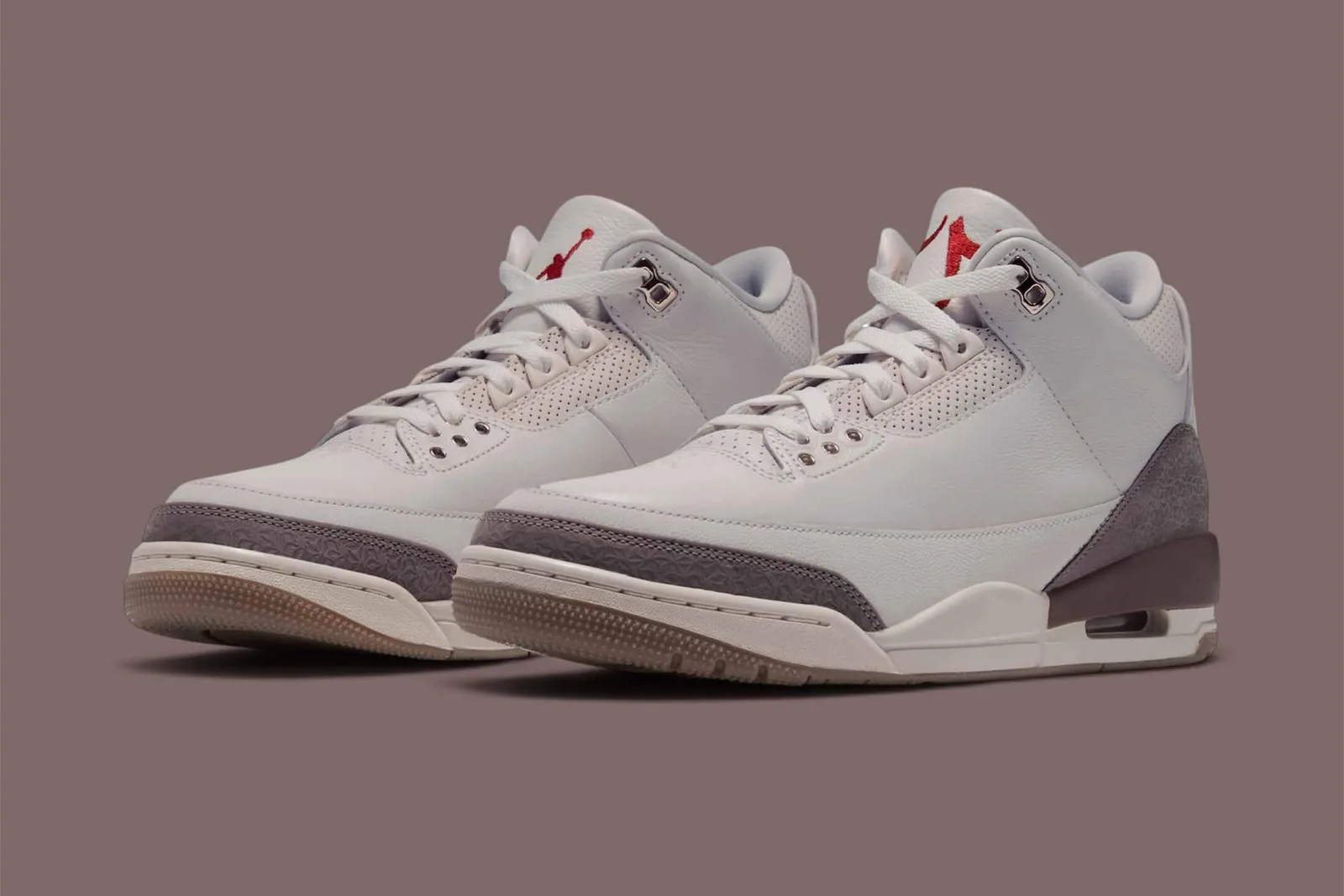 pair shown at an angle on mauve background, grey uppers with dark mauve heel detail, Middle East
