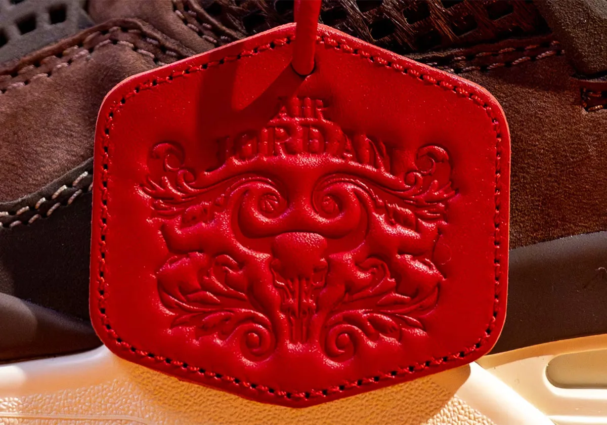 Close-up of stitched red leather hangtag with embossed skull and Air Jordan text, Bin23