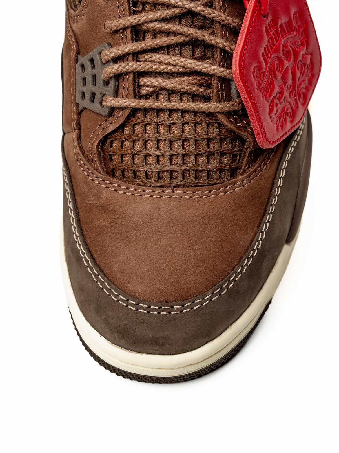 Detail of toe box, brown nubuck, woven grid panel, laces and red tag edge, Bin23