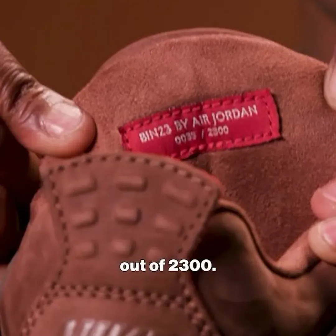 In-hand view of red BIN23 by Air Jordan suede label inside shoe, caption out of 2300, Bin23