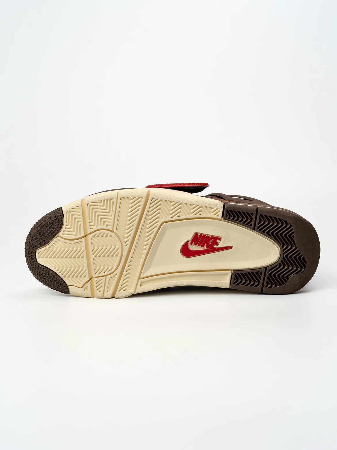 Outsole view, cream tread with brown rubber tips and red Nike logo on the shank, Bin23