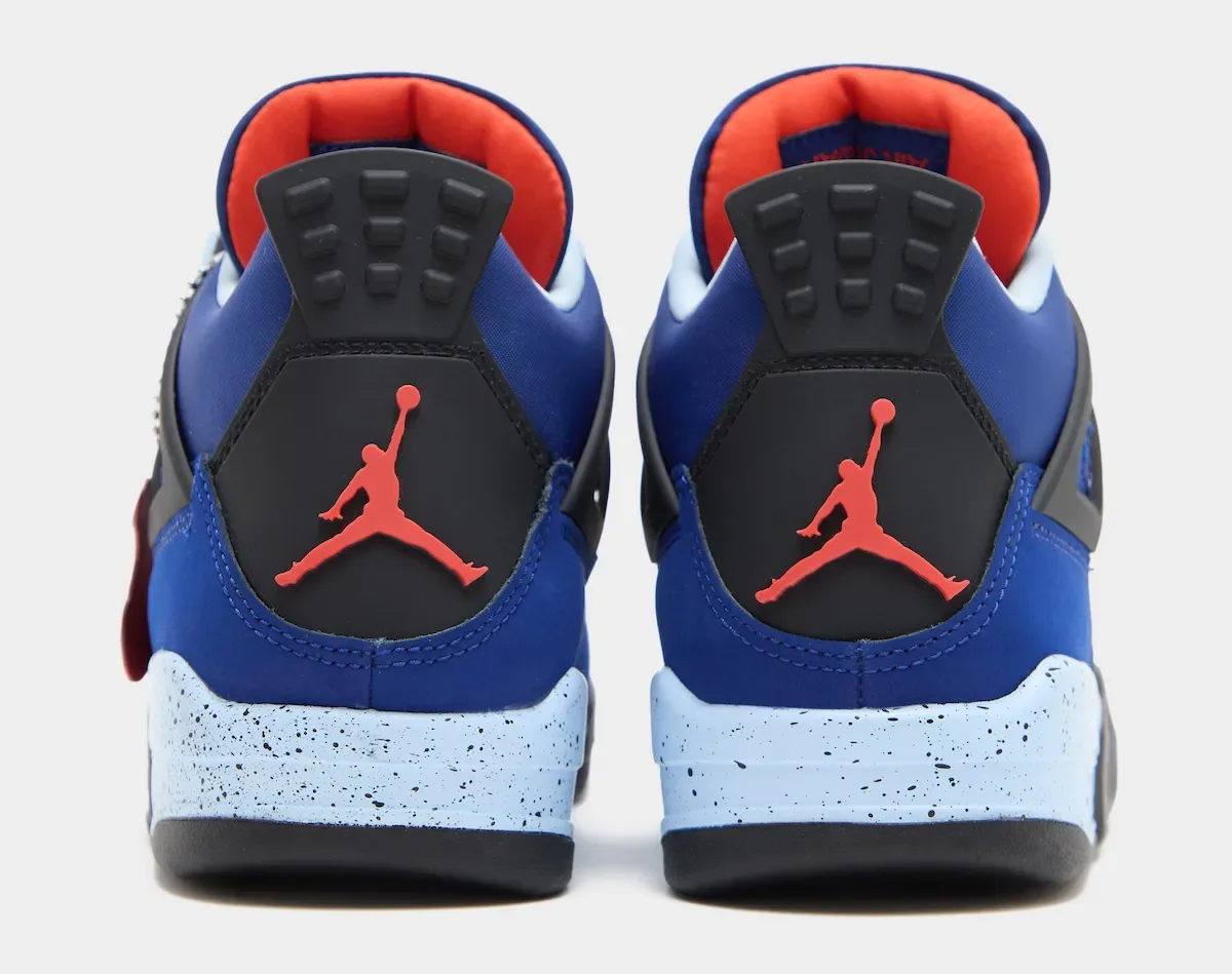 Heel view of pair with red Jumpman logos on black heel tabs, orange liners, Deep Royal Blue