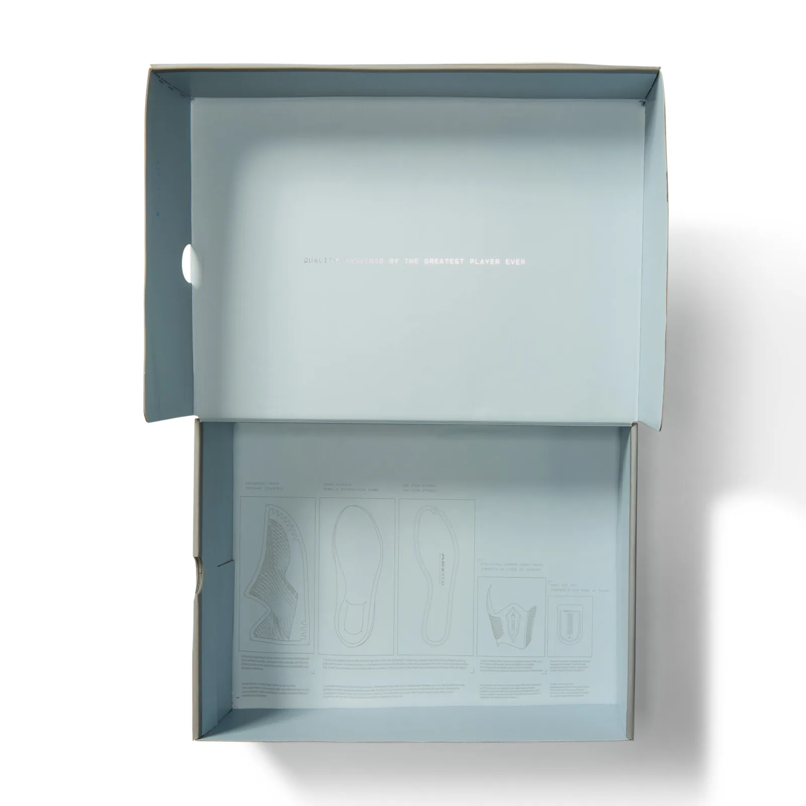 Open grey-blue shoebox, inside text reading quality inspired by the greatest player ever, Space Jam