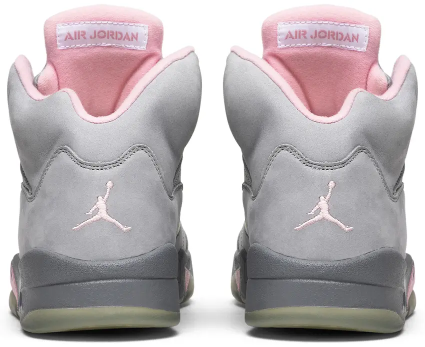 Heel view of pair showing pink Jumpman logos, Air Jordan label on pink tongue and grey midsole, Shy Pink
