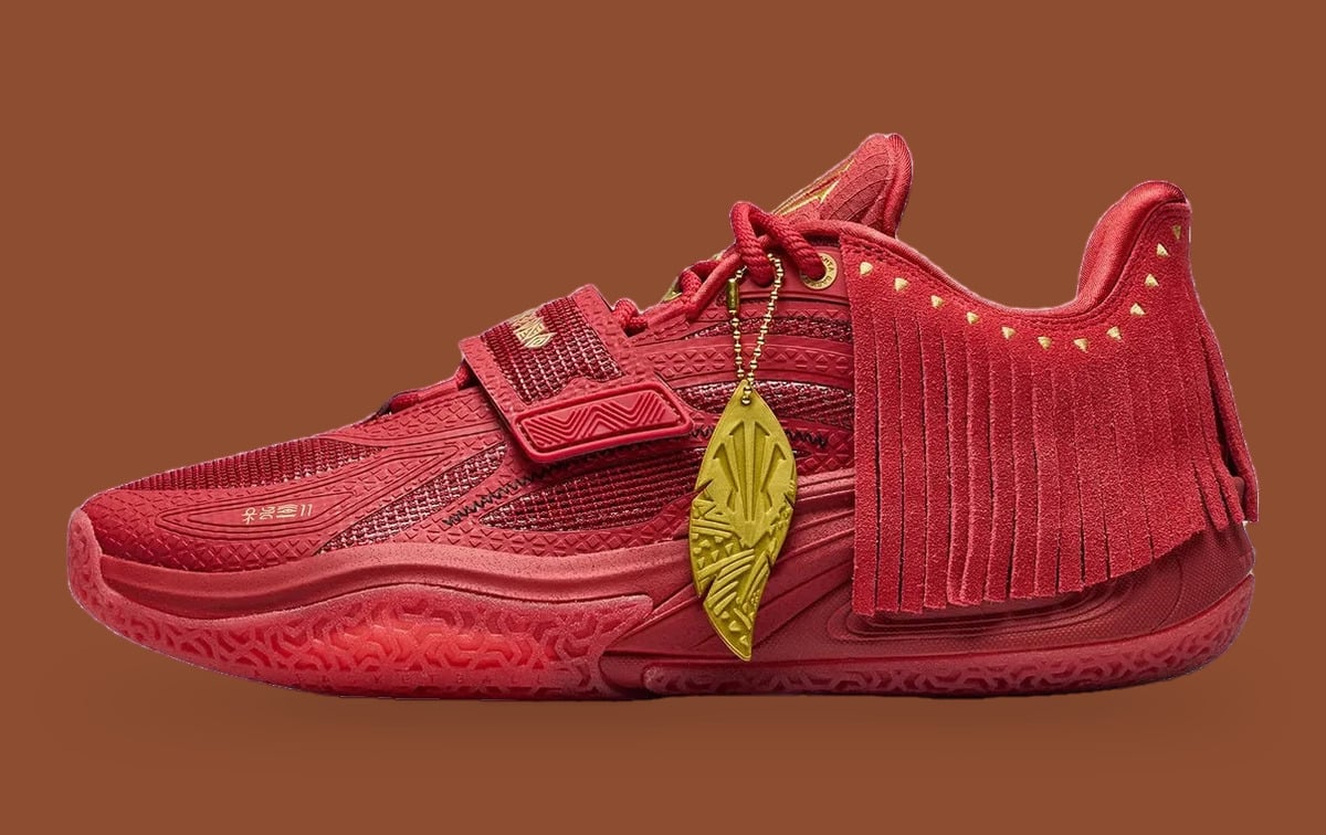 Lateral view, all-red shoe with suede fringe, gold studs and gold feather charm, Red