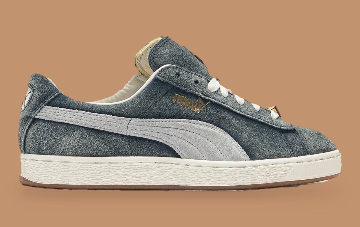 Lateral view of faded grey-blue suede with pale grey formstripe, gold logo, gum sole, Faded Blue