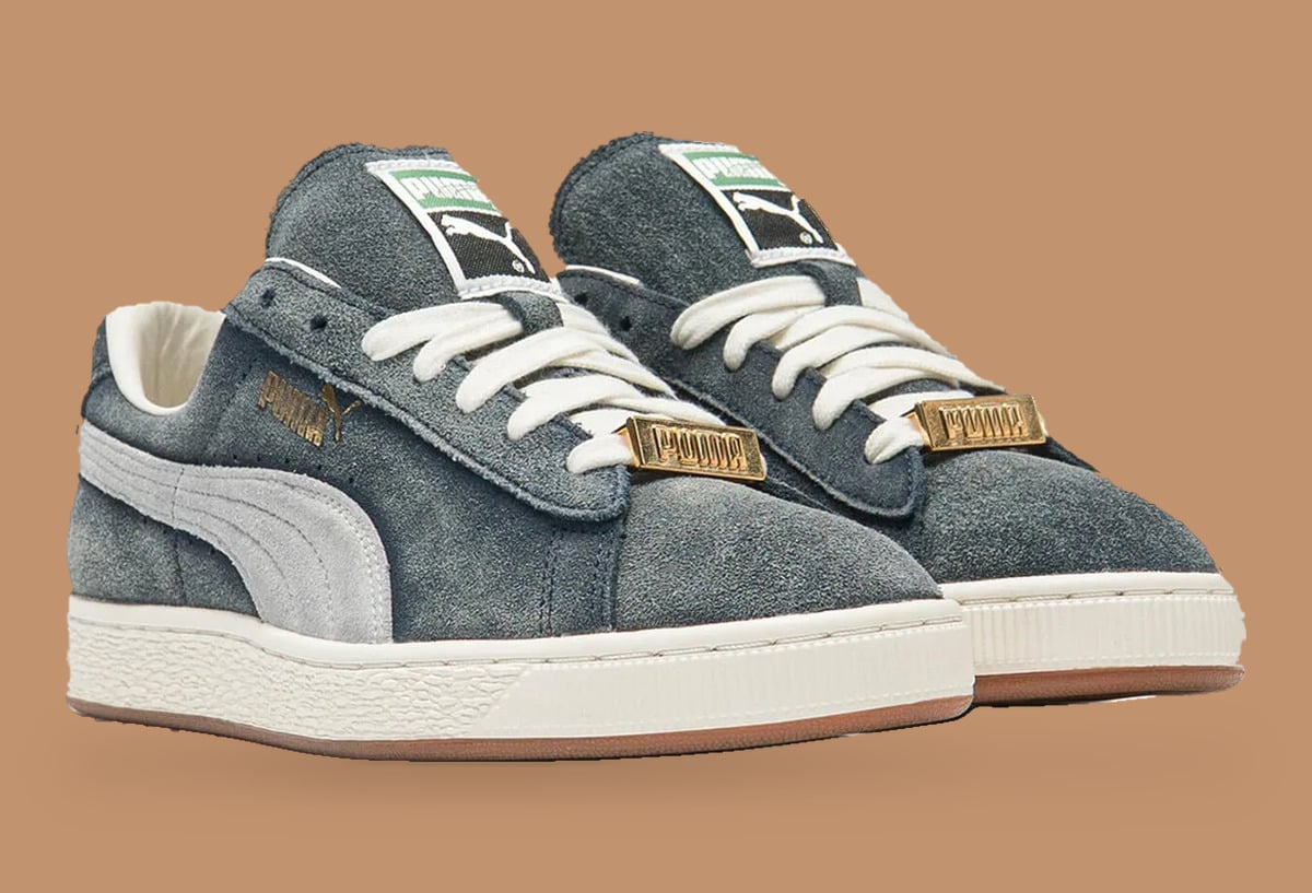 Pair, front three-quarter view with gold PUMA lace plaques and cream laces on tan, Faded Blue