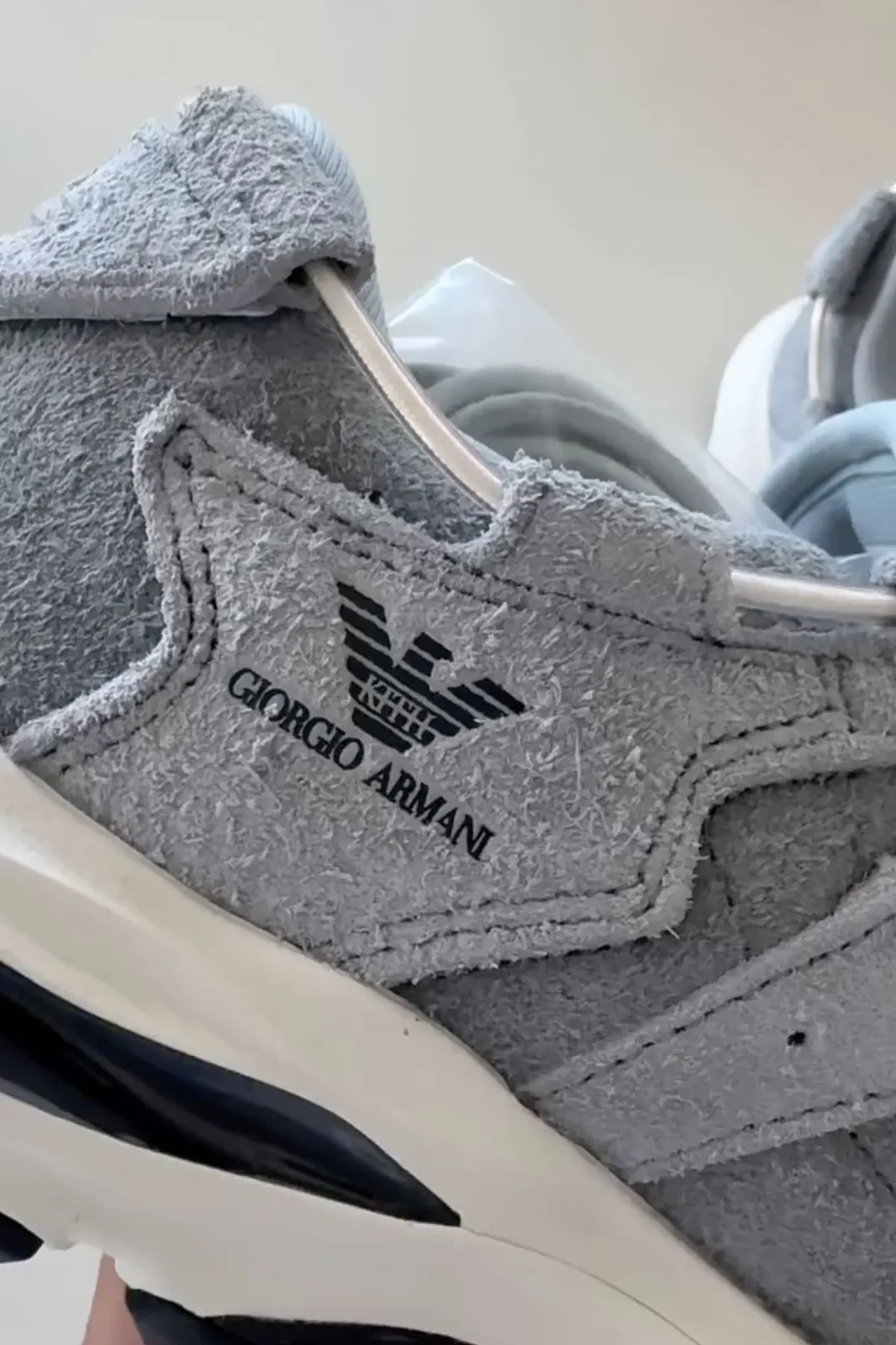 Medial side detail, black Giorgio Armani eagle logo on blue-grey suede, white midsole, x Giorgio Armani