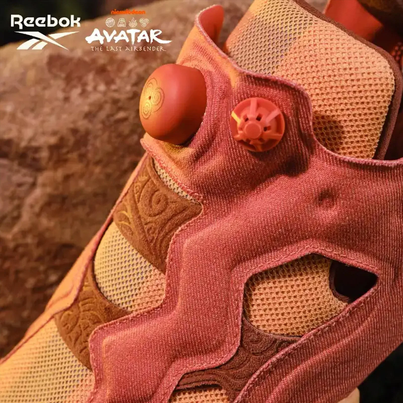 Close-up of pump button and terracotta fabric, Reebok and Avatar logos, rock background, Aang
