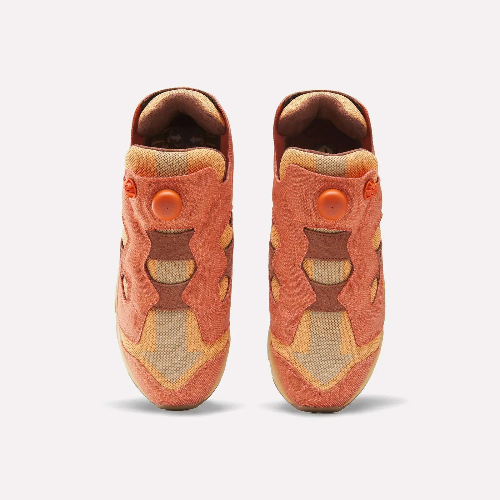 Top-down view of pair, orange pump buttons, tan arrow graphic on toe box, Aang