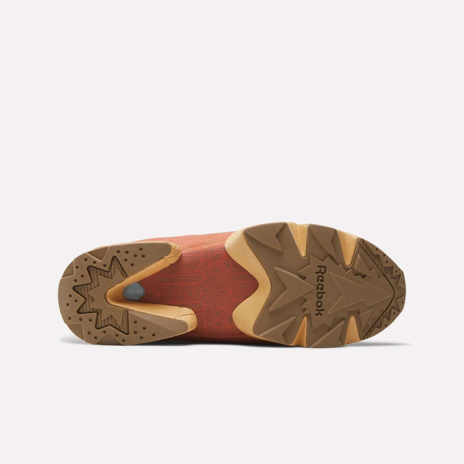 Outsole view with Reebok logo, brown star-shaped tread, red spiral-patterned midfoot, Aang