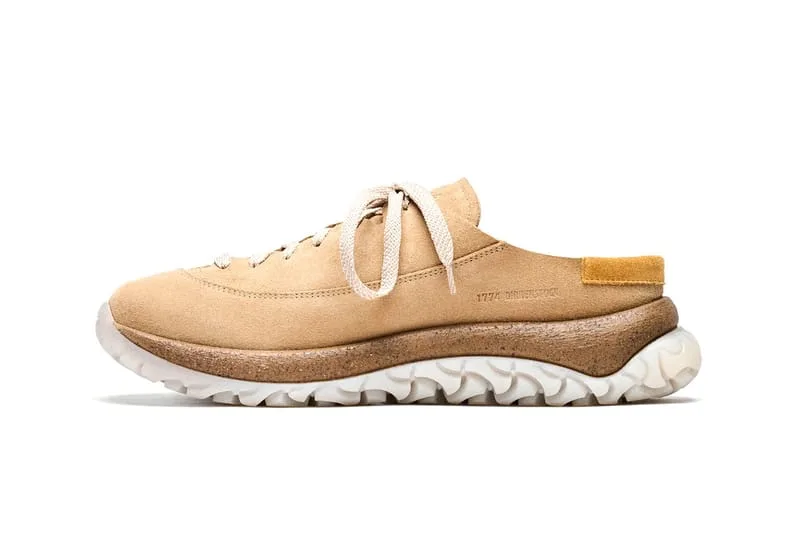 Lateral view of a tan suede lace-up mule with a mustard heel tab and white wavy outsole, Birkenstock 1774 Uerzell