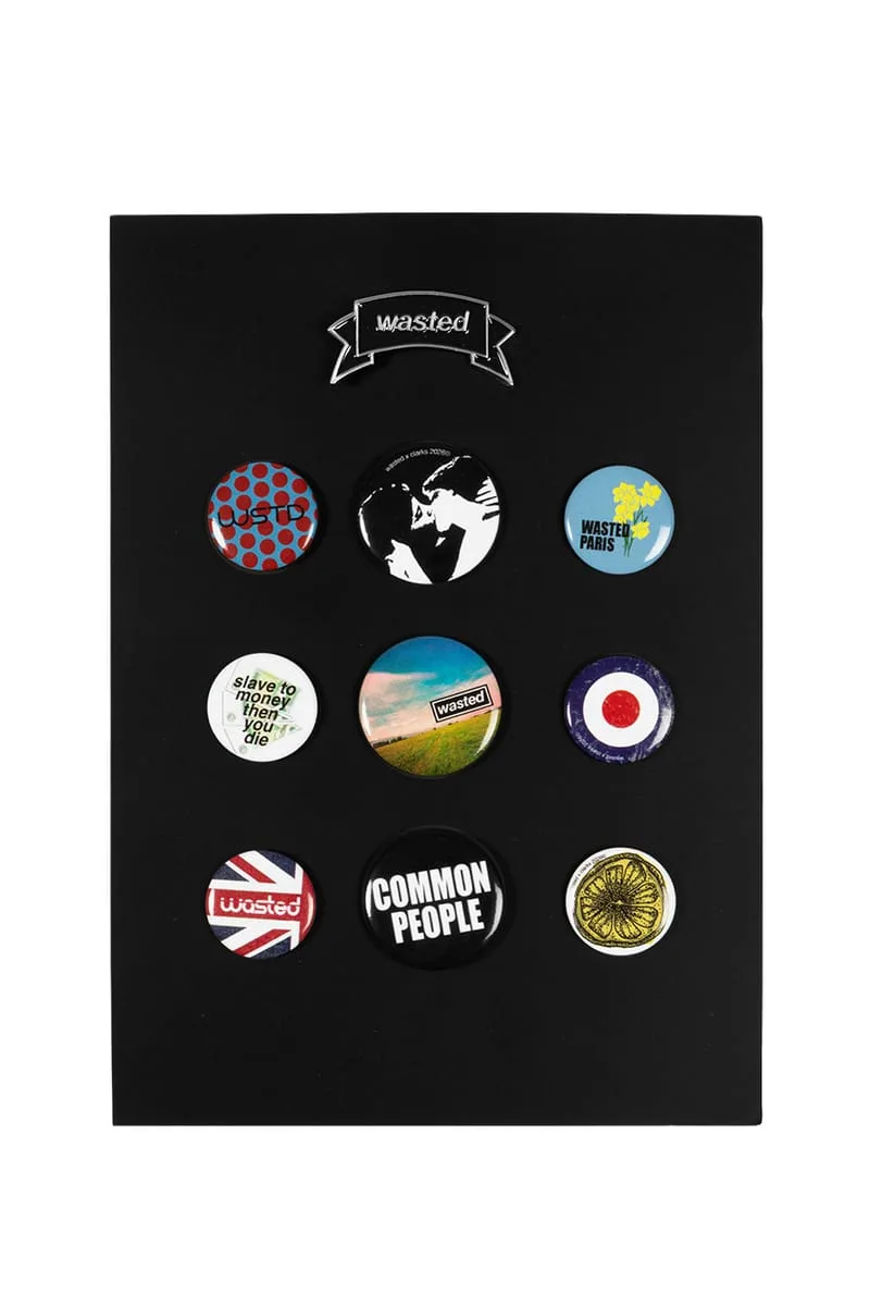 Black display card with a silver Wasted banner pin and nine round badges, x Wasted Paris