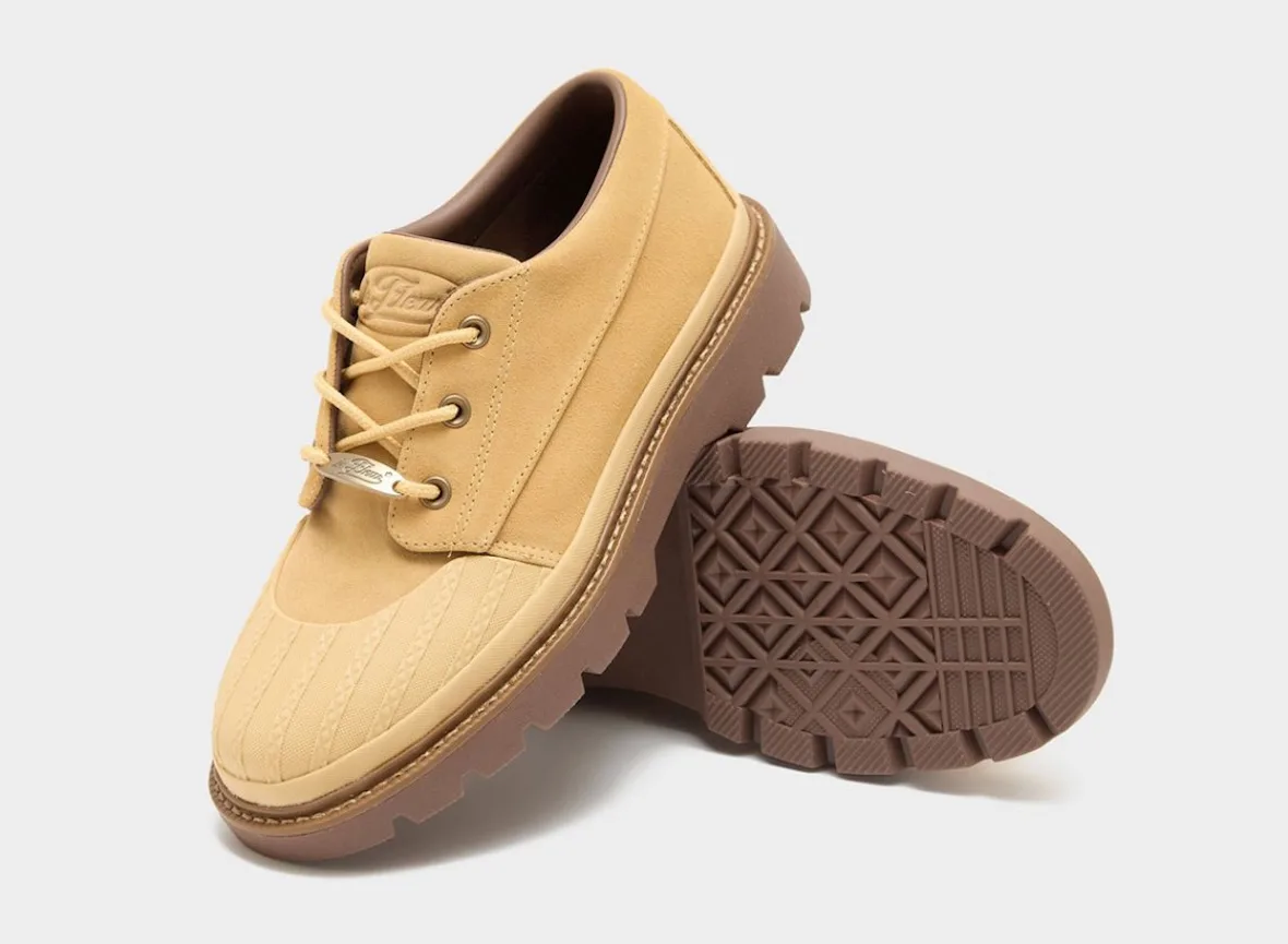 Tan suede shoe beside upturned diamond-tread outsole, gum sole, gold lace tag, Bronco Boot Low