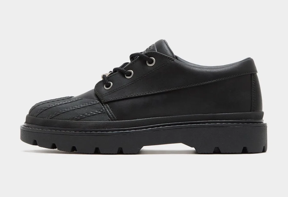 Lateral view of black leather shoe, ribbed toe cap, silver eyelets, chunky lugged sole, Bronco Boot Low