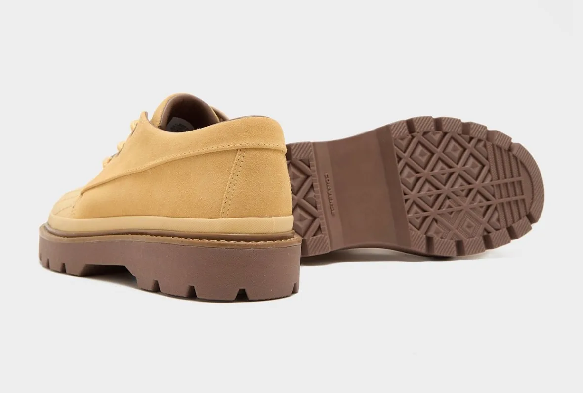 Heel view of tan suede shoe with outsole shown, brown diamond tread, Converse text, Bronco Boot Low