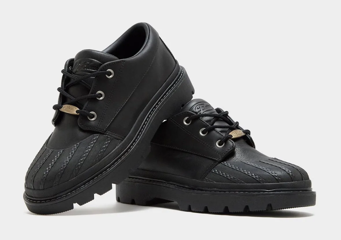 Pair in black leather, one stacked on the other, rubber toe cap, gold lace tag, Bronco Boot Low