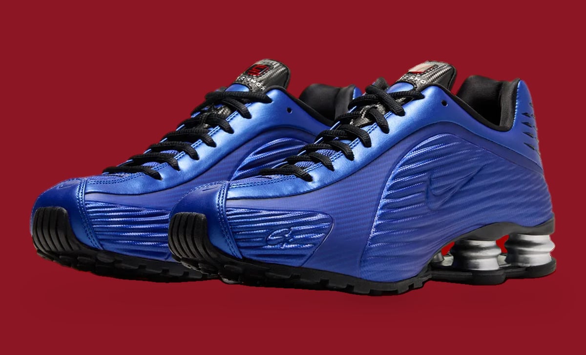Pair, front three-quarter view: metallic blue ridged uppers, black laces, silver heel springs, Game Royal