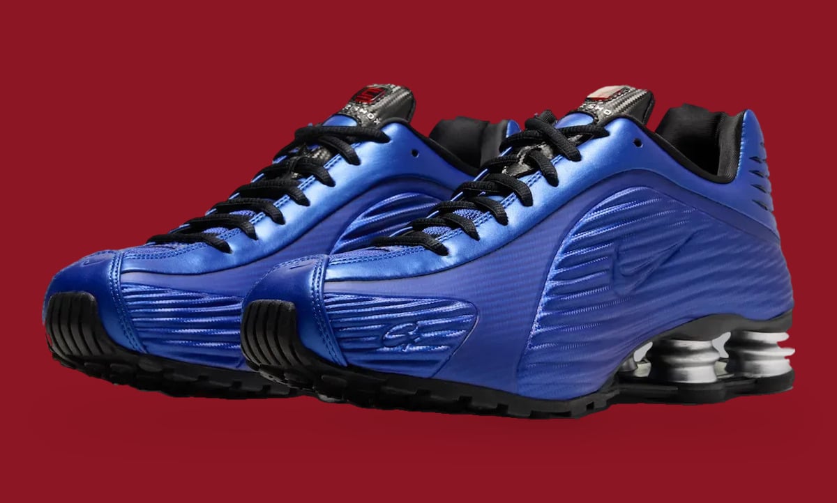 Pair, three-quarter view: glossy blue ribbed uppers, black laces and outsoles, silver heel columns, Game Royal