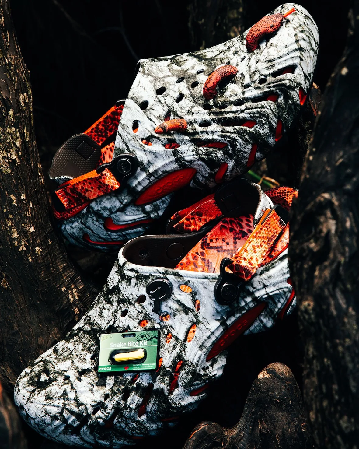 Pair stacked on roots, marbled clogs with orange snake charms, snakeskin heel straps and Snake Bite Kit charm, Watch Your