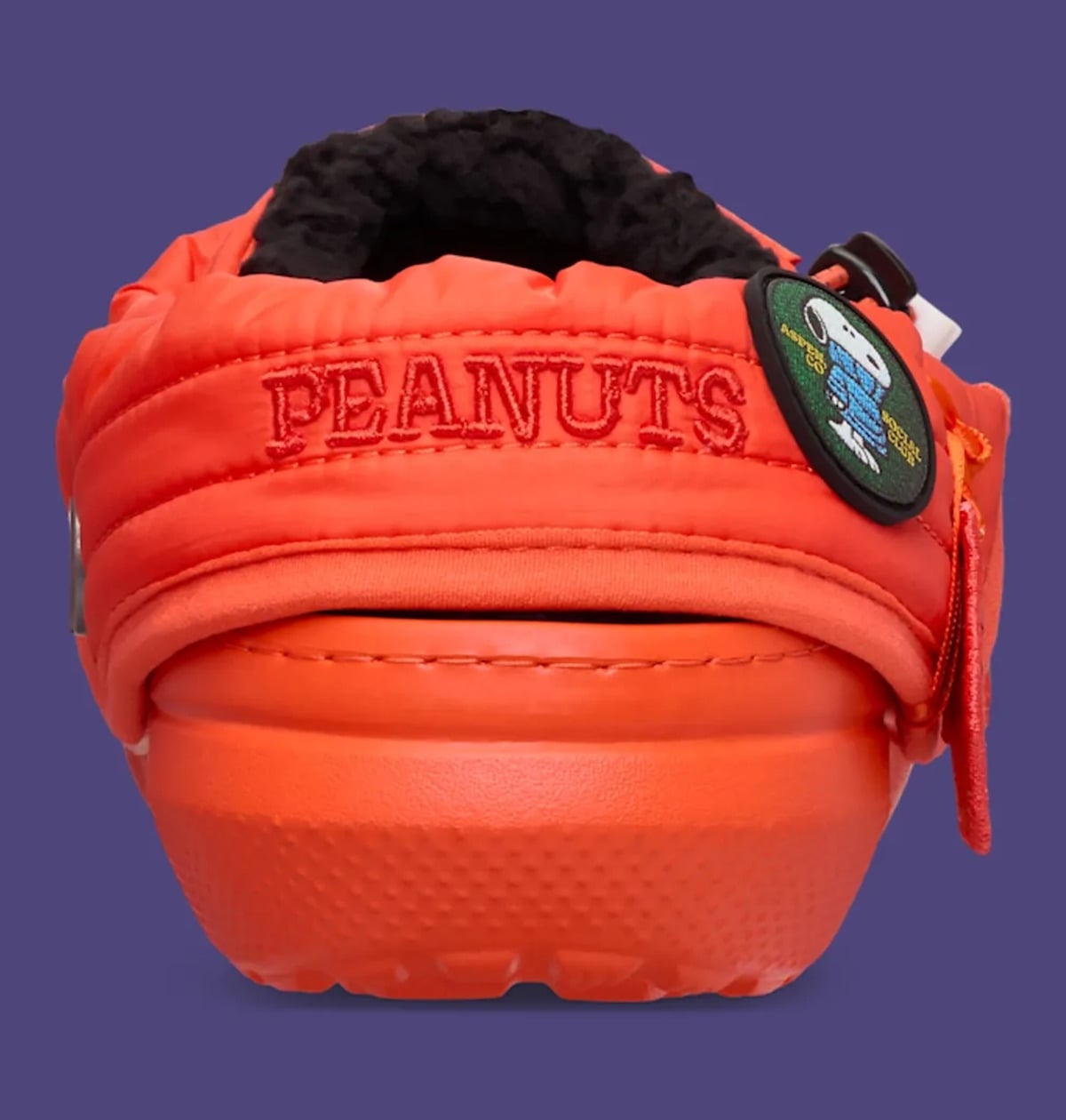 Heel view with embroidered PEANUTS text, green Snoopy patch and black fleece, Classic Lined Clog
