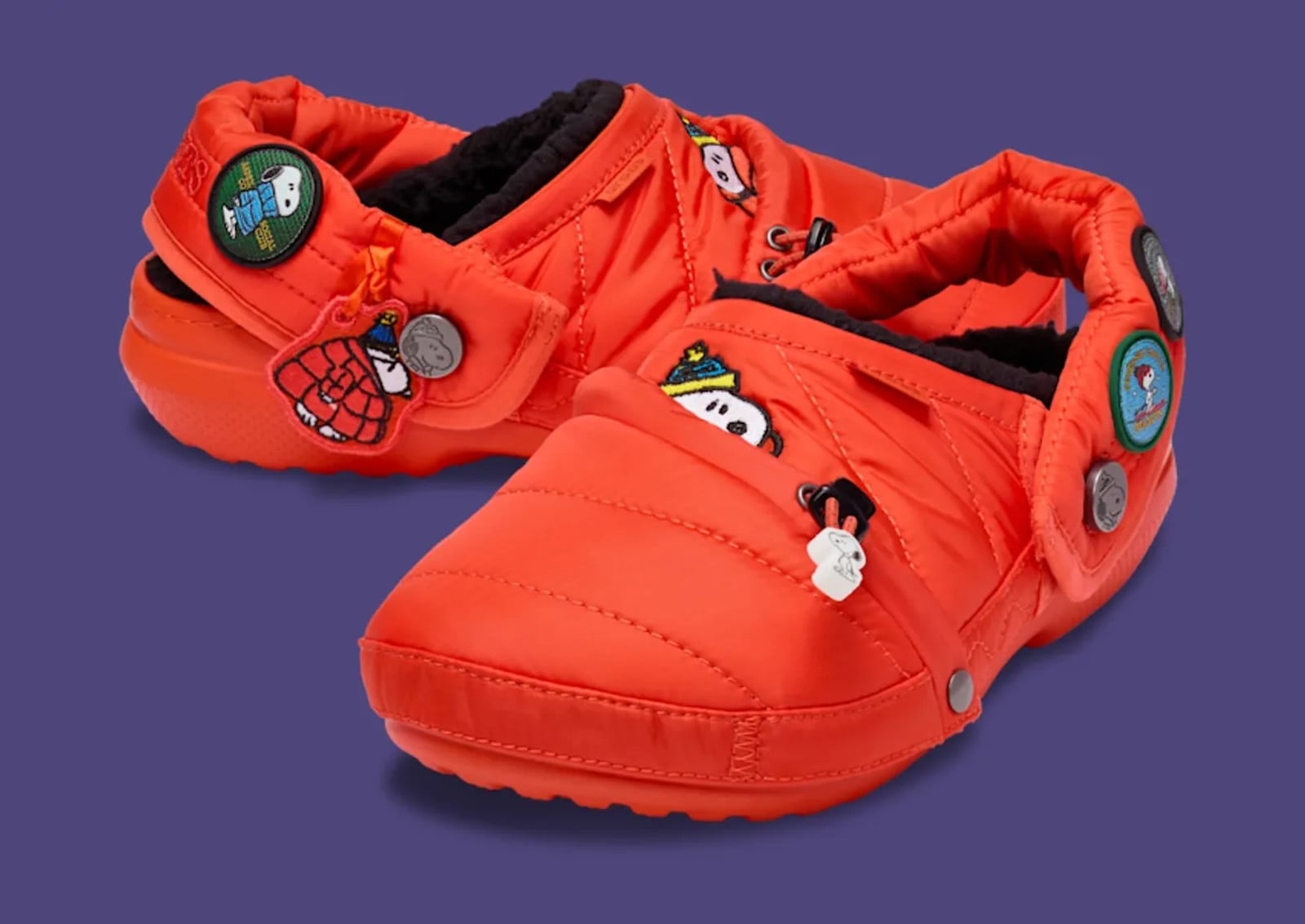 Pair at three-quarter angle, orange quilted nylon with Snoopy patches on purple, Crocs Peanuts Joe Cool Classic Lined Clog