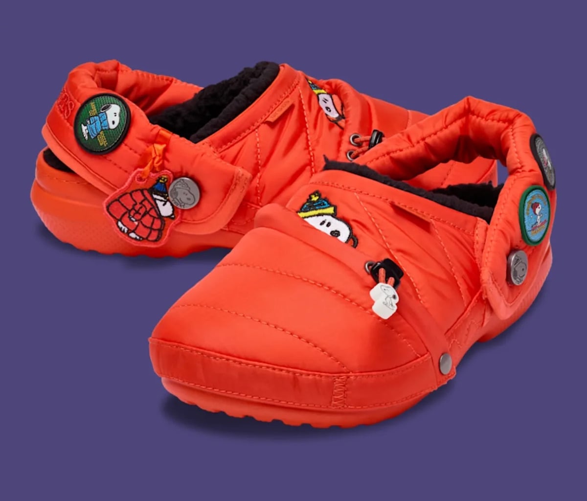 Pair angled view, orange puffy nylon, Snoopy badges and black fleece lining, Classic Lined Clog