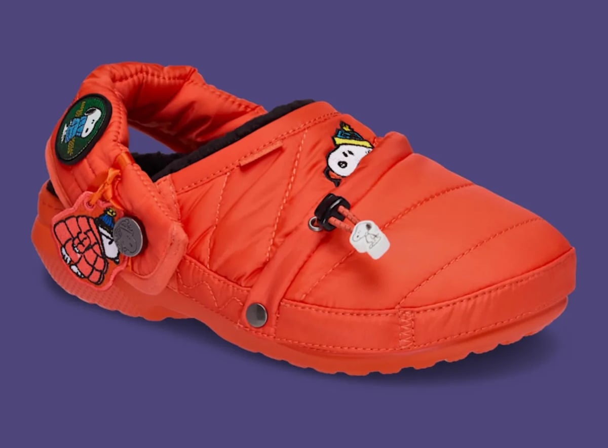 Three-quarter view of orange quilted clog with Snoopy patch and bungee toggle, Classic Lined Clog