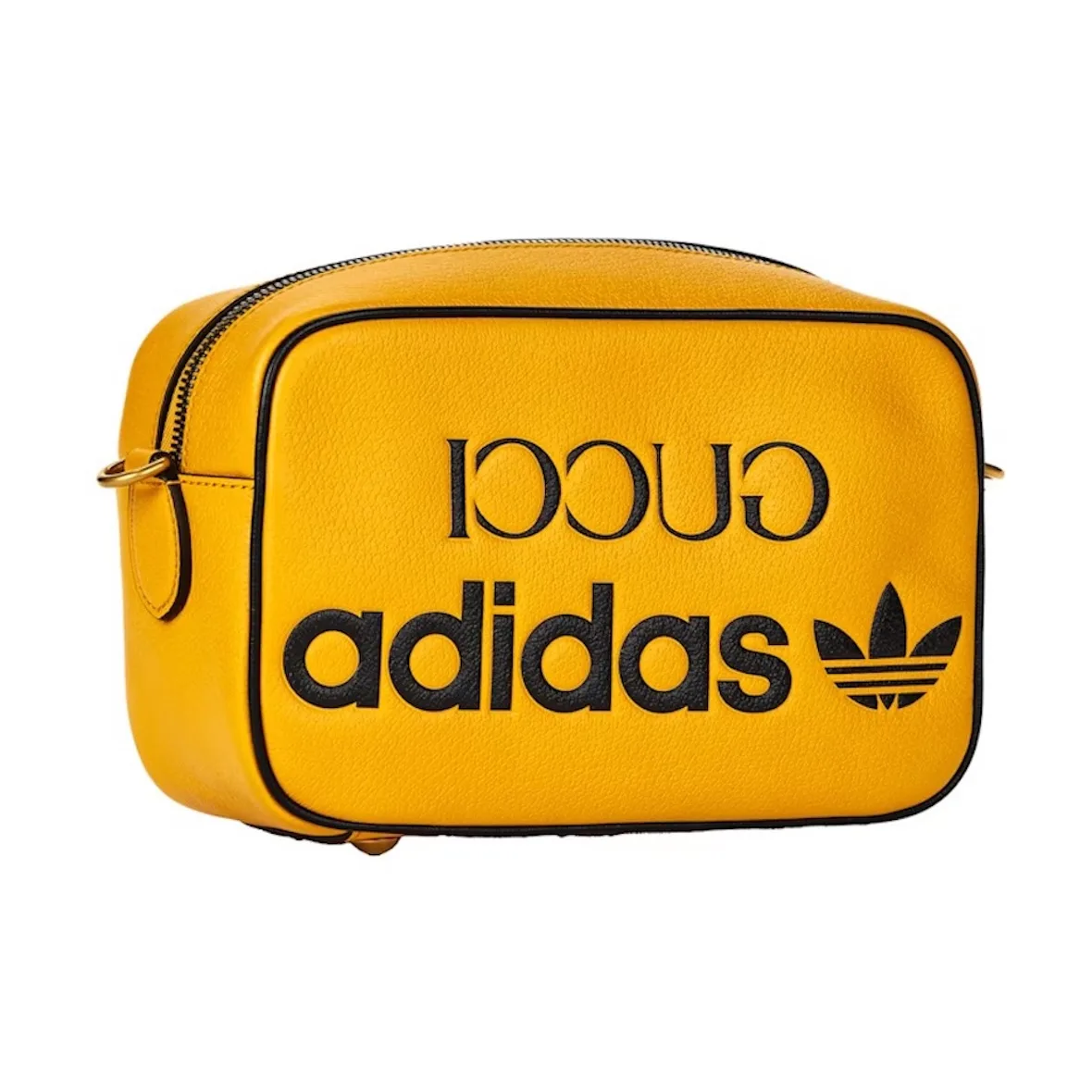 Three-quarter view of mustard yellow leather bag with black mirrored Gucci and adidas logos, StockX LISTED Collection