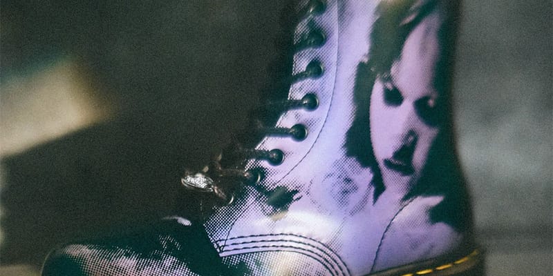 Tight crop of boot shaft showing halftone purple face print, black eyelets and laces, The Exorcist