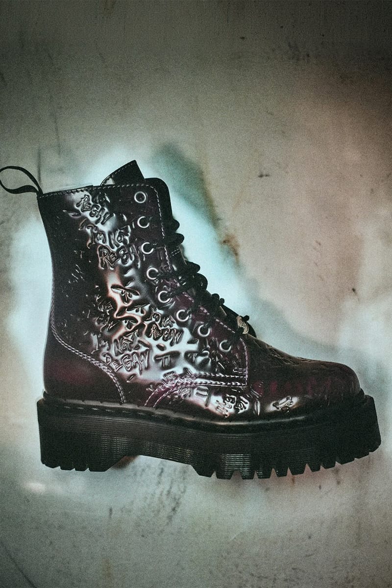 Lateral view of glossy burgundy platform boot with embossed scrawled text on a mottled grey backdrop, The Exorcist