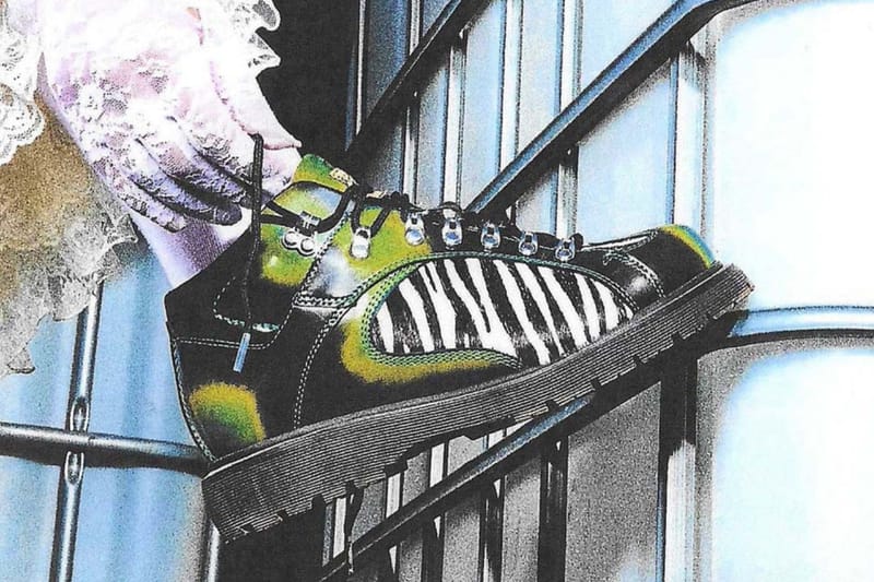 On-foot view of green zebra-print boot on a metal frame, lace sleeve and blue-tinted background, x Brain Dead