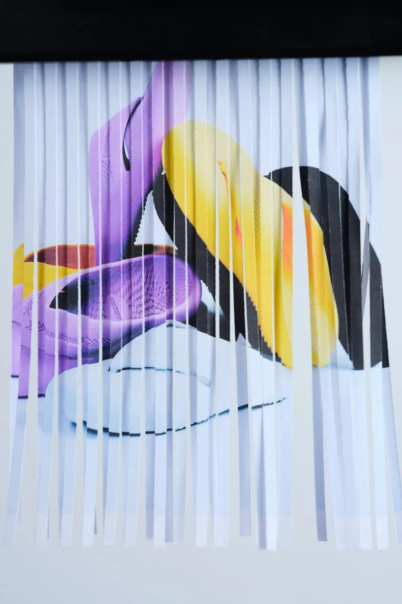 Printed shoe photo feeding through a paper shredder, strips of purple and yellow, Top Toe Mule