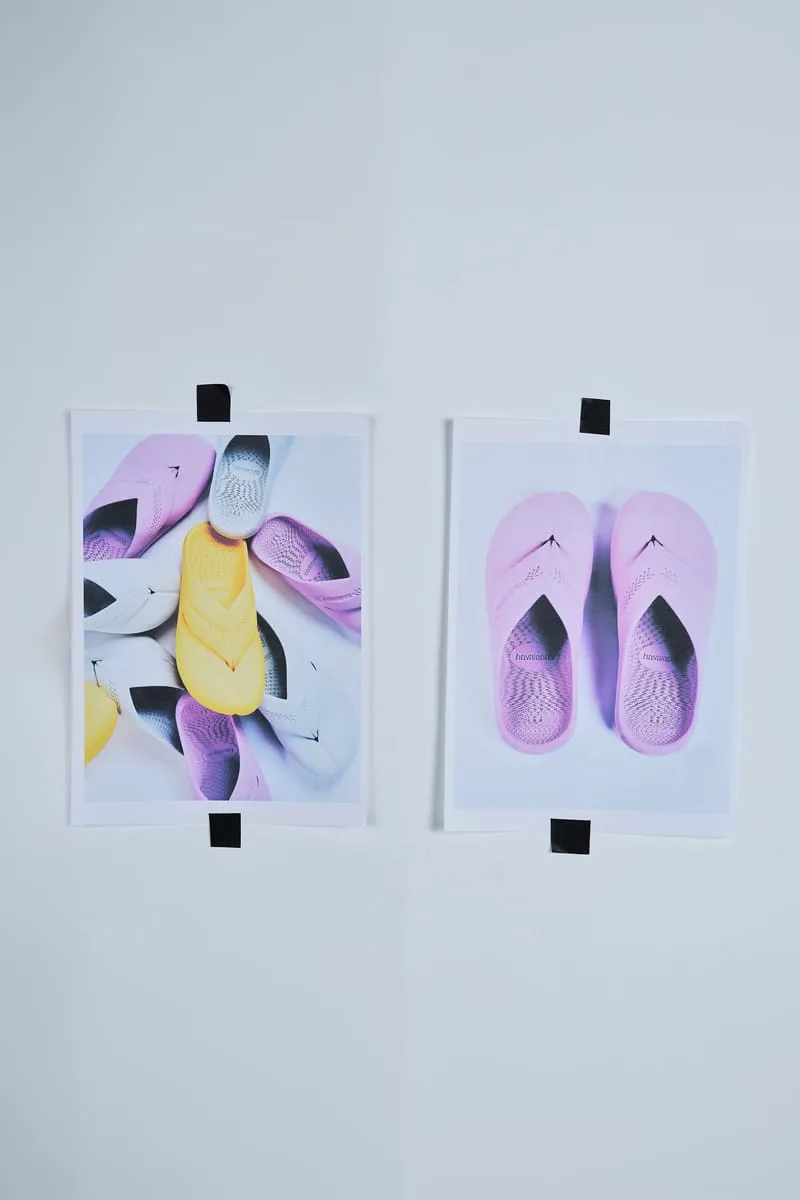 Two printed photos taped to a wall, showing pastel pink, yellow and grey mules, Top Toe Mule