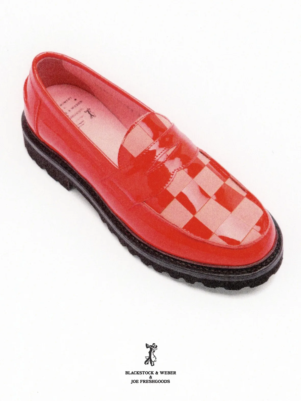 Top-down angled view of a red patent loafer with checkered vamp and chunky black lug sole, Candy Apple