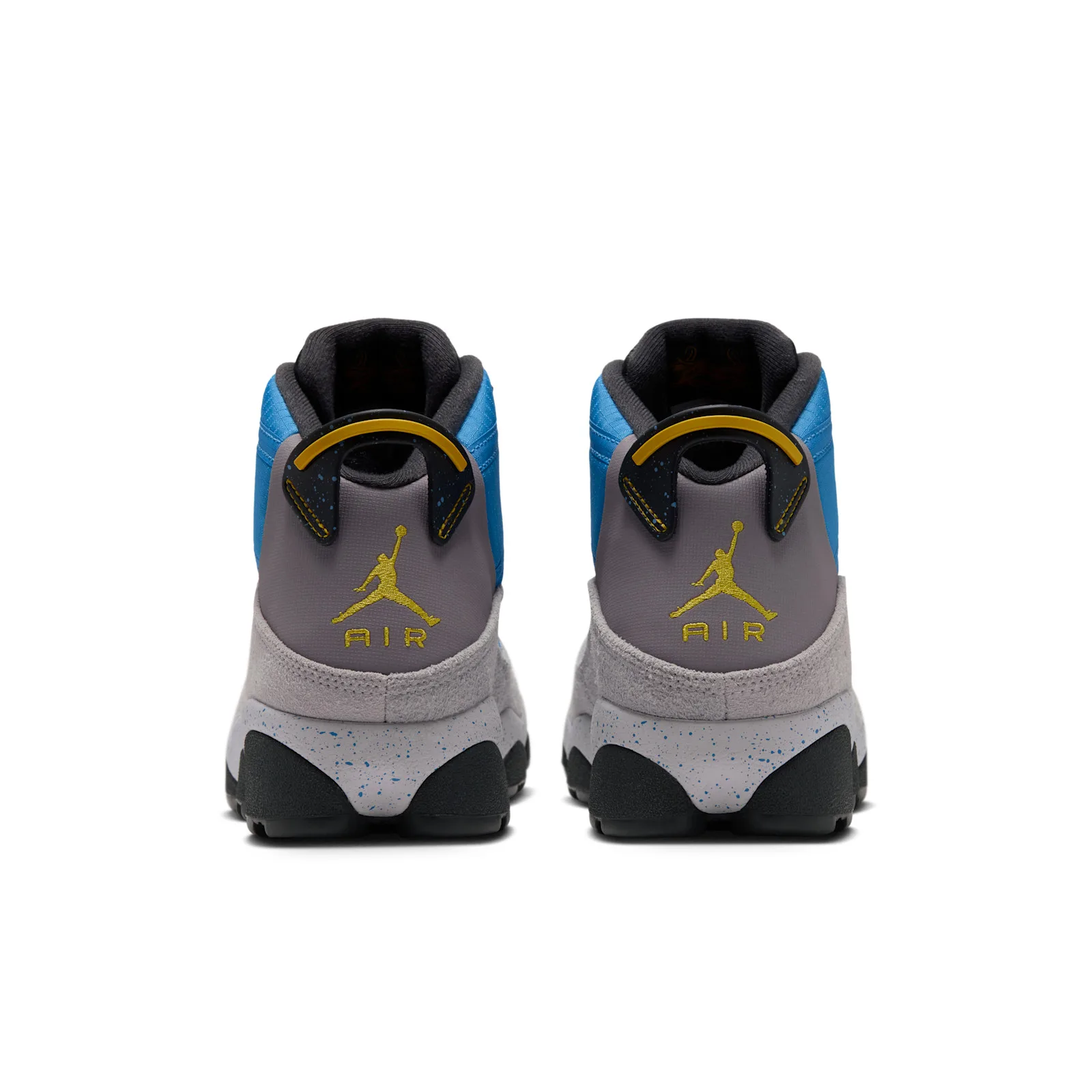 Heel view of a pair with yellow Jumpman and AIR logos on grey heel panels and blue speckled midsoles, Cobalt Blue