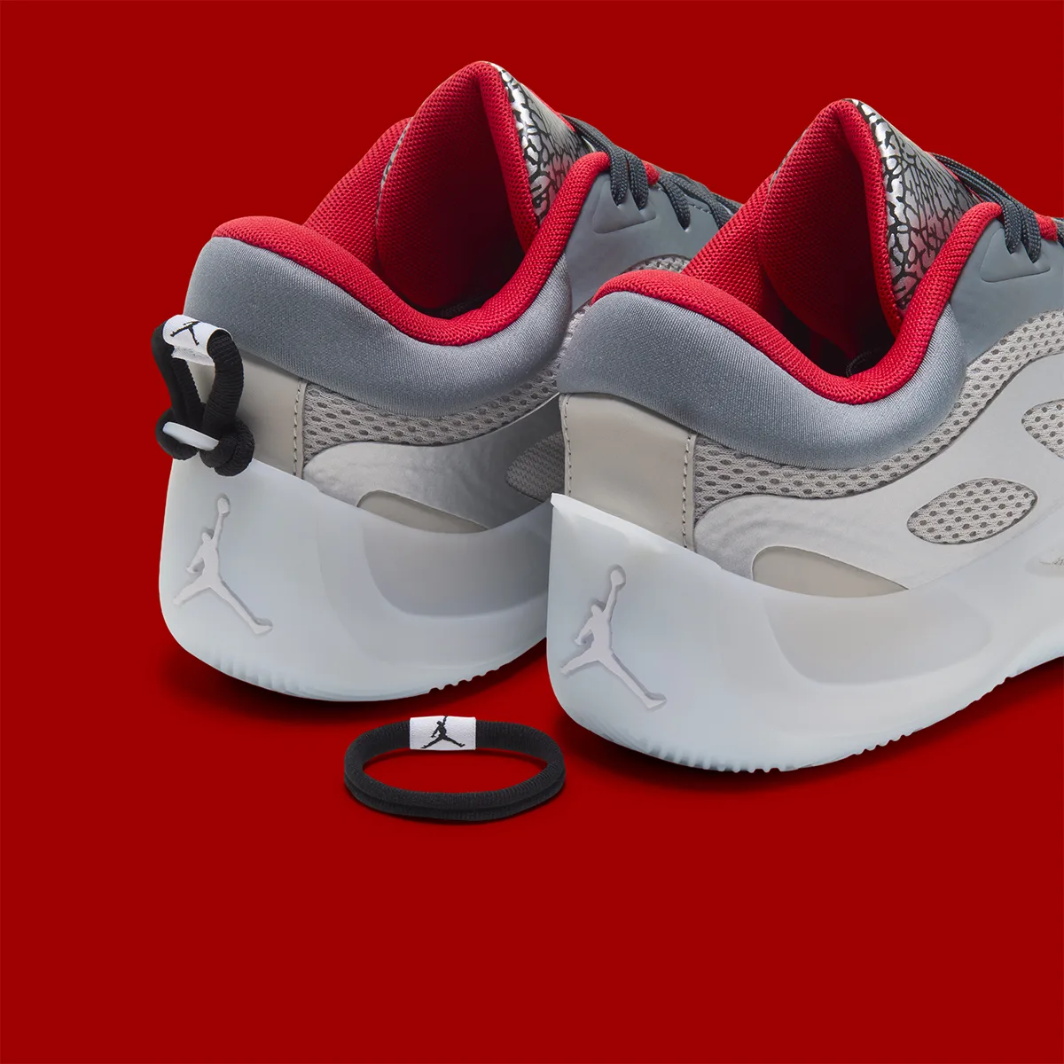 Rear three-quarter pair with red lining and a detached black heel loop, Elephant Print
