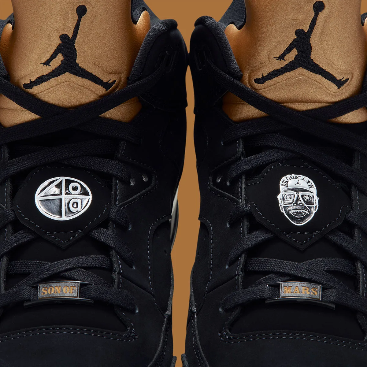 Detail of silver lace badges, Son of Mars lace tags and black Jumpman on gold tongues, Gold Tongue
