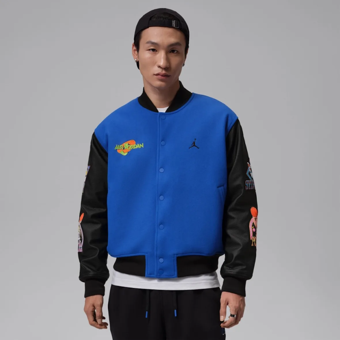 On-model front view of blue wool jacket with black leather sleeves, snap buttons, Varsity Royal/Black
