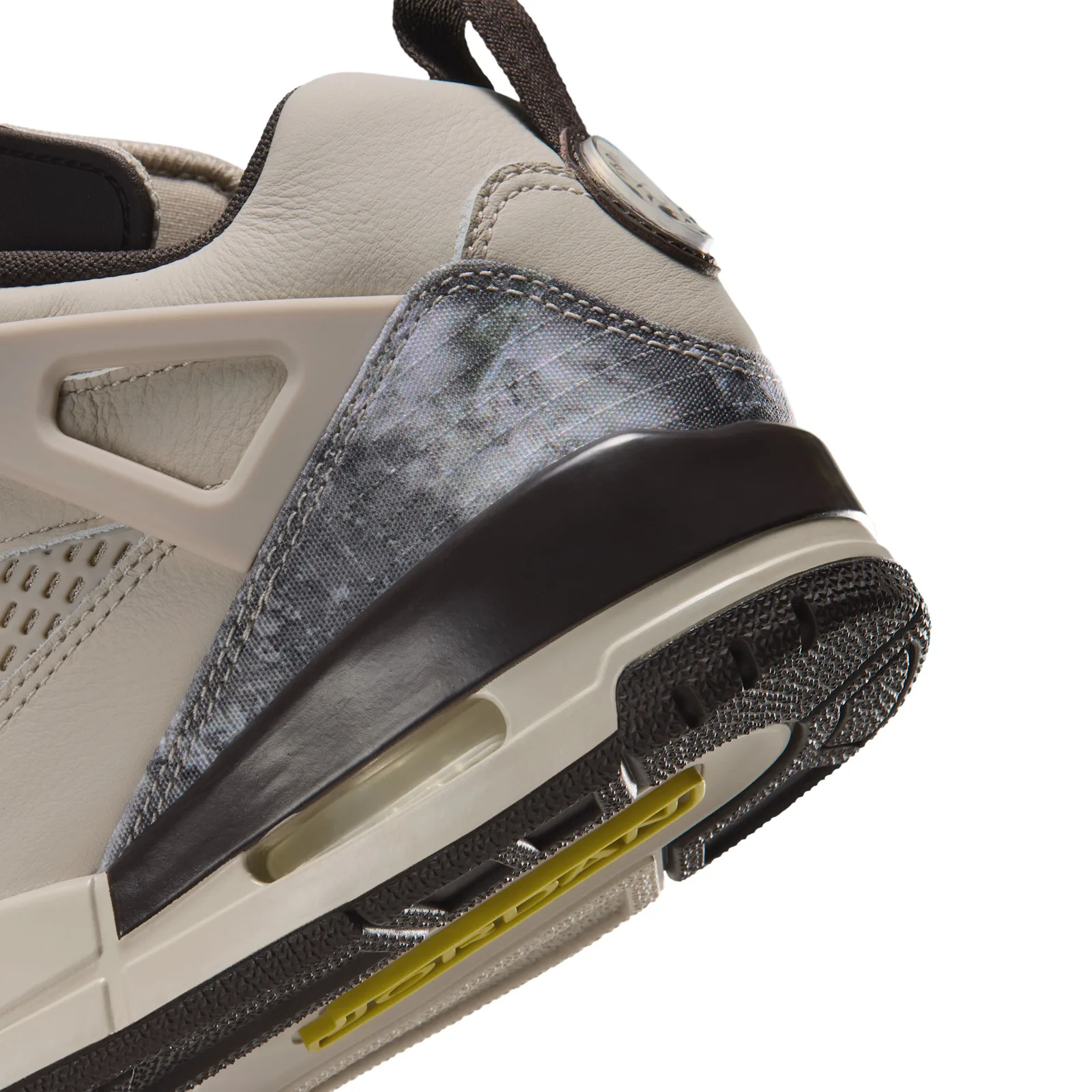 Heel detail, grey camo panel, brown heel unit and yellow Jordan text on the outsole, Realtree Camo