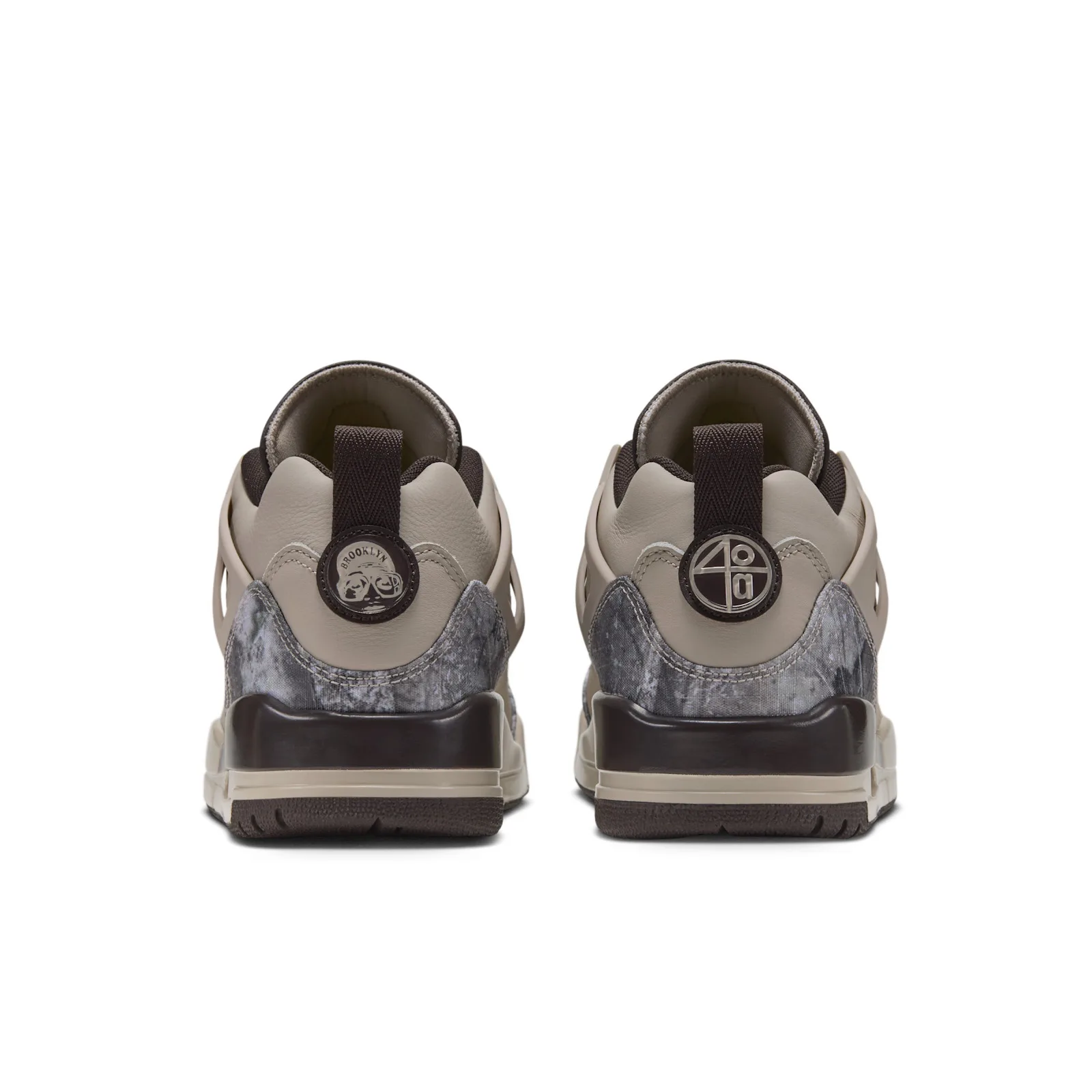 Heel view of pair, round metal heel badges, grey camo panels and brown pull tabs, Realtree Camo